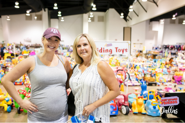 Grandmom, mom and baby in a carrier gather together and flash a smile as they shop for baby items.